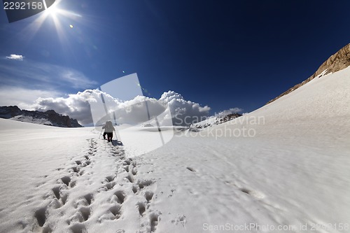 Image of Two hikers on snow plateau.