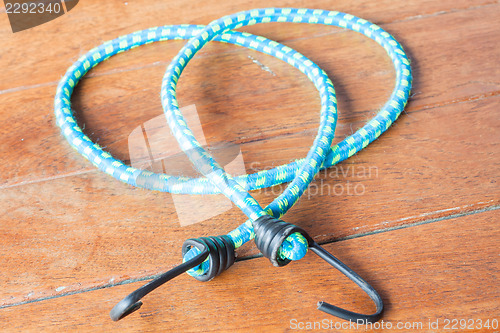 Image of Light blue rubber band with metal hooks