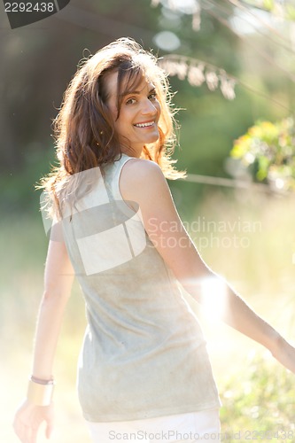 Image of attractive smiling adult woman outside in summer