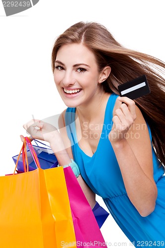 Image of attractive young woman with colorful shopping bags isolated