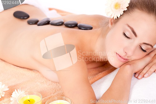 Image of young attractive woman hot stone massage wellness isolated