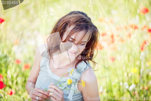 Image of adult brunette woman smiling in summertime outdoor