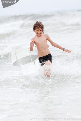 Image of young little boy in water summer holiday fun sea 