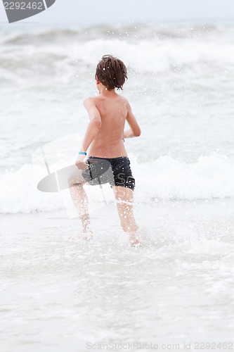 Image of young little boy in water summer holiday fun sea 