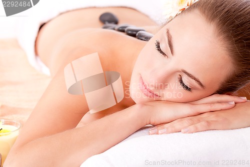 Image of young attractive woman hot stone massage wellness isolated