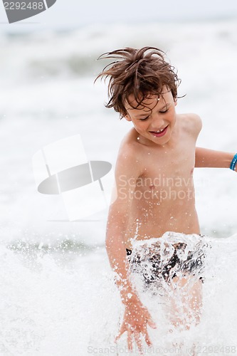Image of young little boy in water summer holiday fun sea 