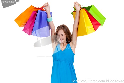 Image of attractive young woman with colorful shopping bags isolated