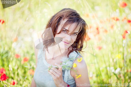 Image of adult brunette woman smiling in summertime outdoor