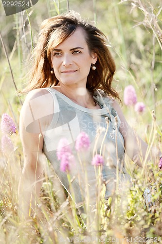 Image of adult brunette woman smiling in summertime outdoor