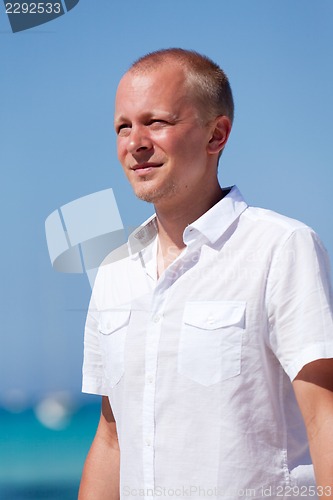 Image of young man walking on the beach in holiday