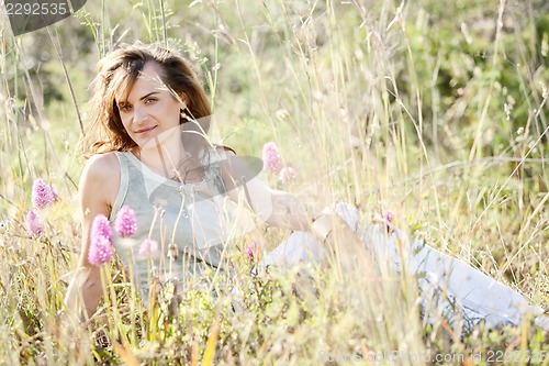 Image of adult brunette woman smiling in summertime outdoor