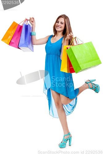 Image of attractive young woman with colorful shopping bags isolated