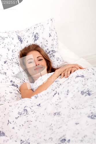 Image of young brunette woman lying in bed sleeping morning 