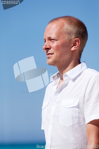 Image of young man walking on the beach in holiday