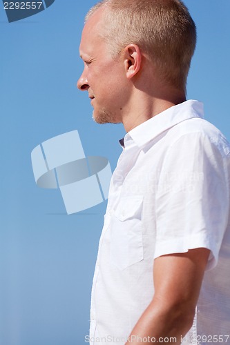 Image of young man walking on the beach in holiday