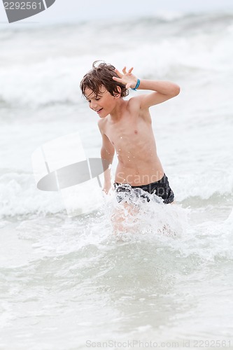 Image of young little boy in water summer holiday fun sea 