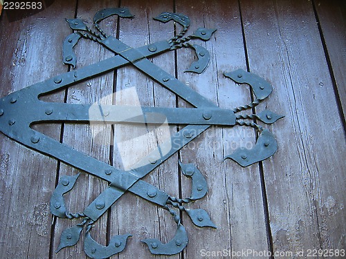 Image of beautiful wooden gate with iron patterns