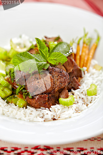 Image of meat and vegetables on white plate