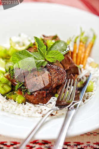 Image of meat and vegetables on white plate