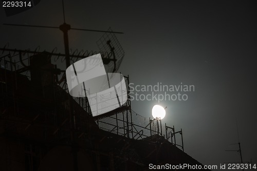 Image of Full moon over the roofs