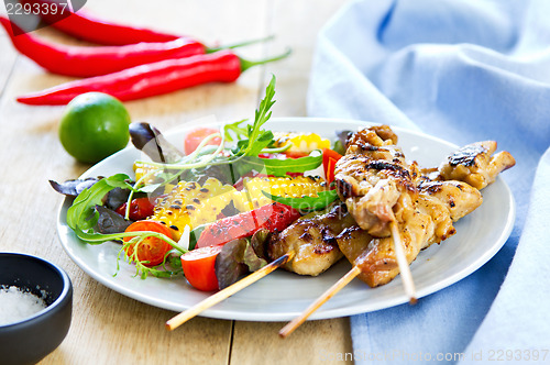 Image of Grilled chicken skewer with salad