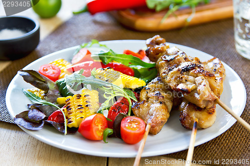 Image of Grilled chicken skewer with salad