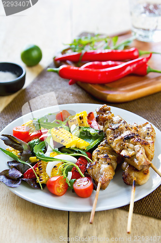 Image of Grilled chicken skewer with salad