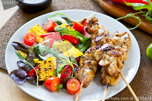 Image of Grilled chicken skewer with salad