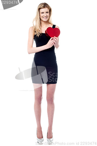 Image of Tall attractive girl holding heart shaped gift
