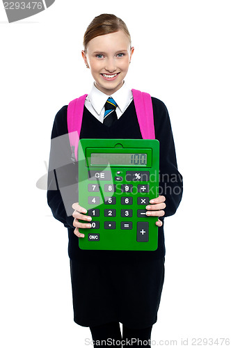 Image of School girl holding large green calculator