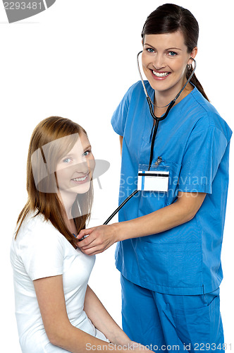 Image of Friendly doctor examining her patient