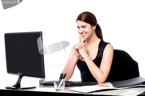 Image of Smiling corporate lady in her office