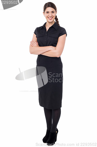 Image of Smiling business executive with arms crossed