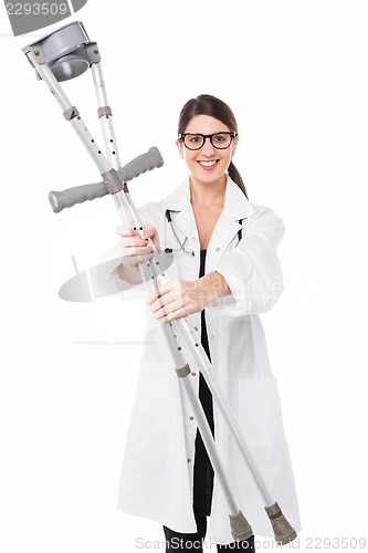 Image of Female doctor handing over crutches