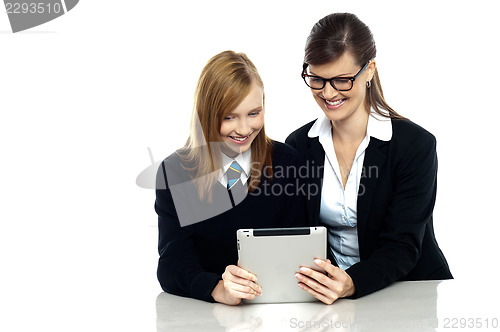 Image of Teacher and student busy in tablet device