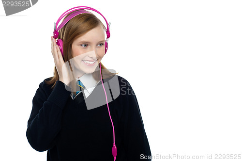 Image of Pretty schoolgirl enjoying music