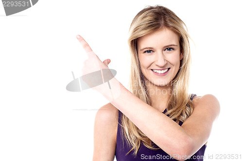 Image of Charming female model pointing away