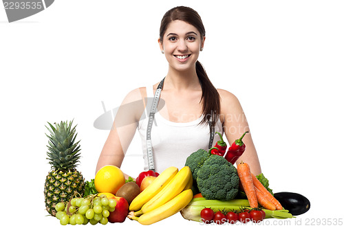 Image of Beautiful young woman with fruits