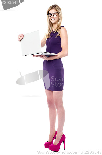 Image of Stylish teenager holding new laptop