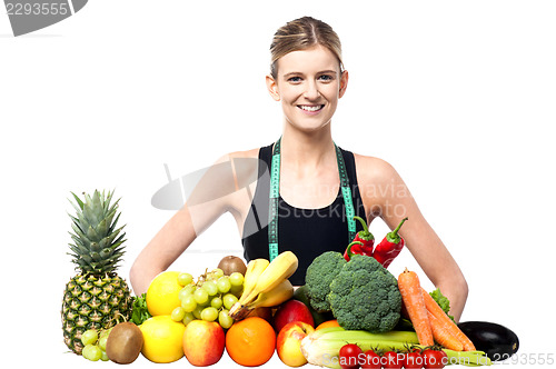 Image of Slim fit girl with fresh fruits and vegetables