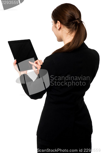 Image of Business executive operating touch pad