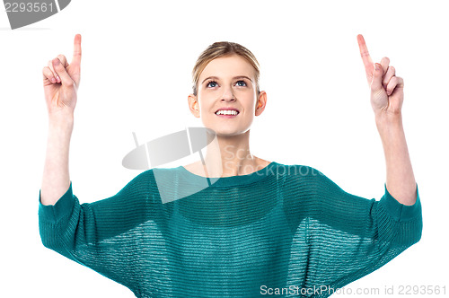Image of Pretty teen pointing upwards