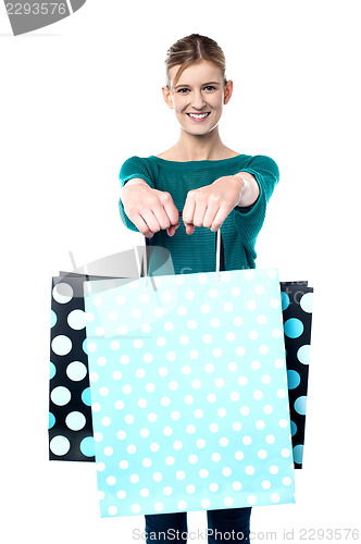 Image of Young shopaholic girl with vibrant bags