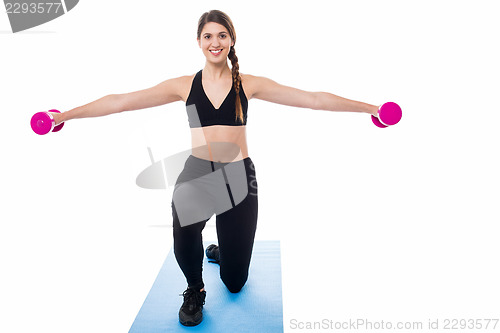 Image of Female trainer exercising with dumbbells