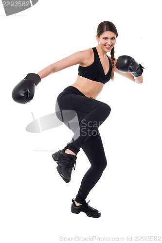 Image of Pretty young boxer woman in action