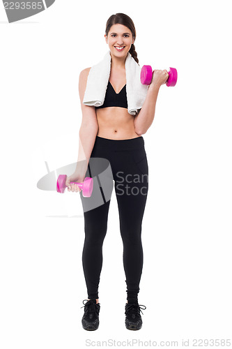 Image of Fitness female instructor lifting dumbbells