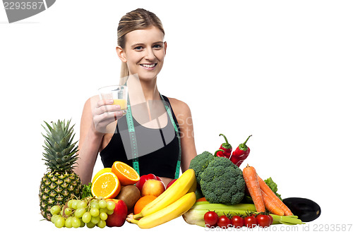 Image of Pretty girl holding glass of fresh juice