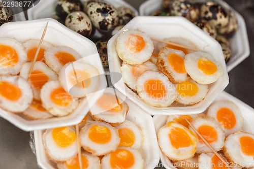 Image of Scrambled quail eggs and boiled eggs at market
