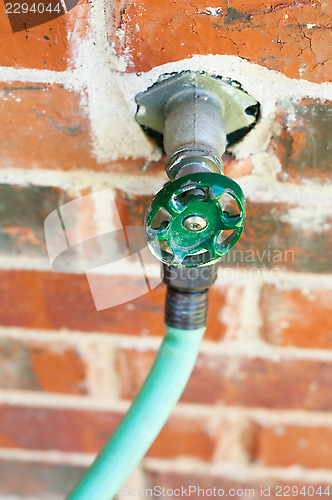 Image of A water faucet of a suburban home.