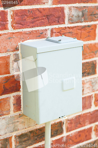 Image of Electric control box on red brick wall